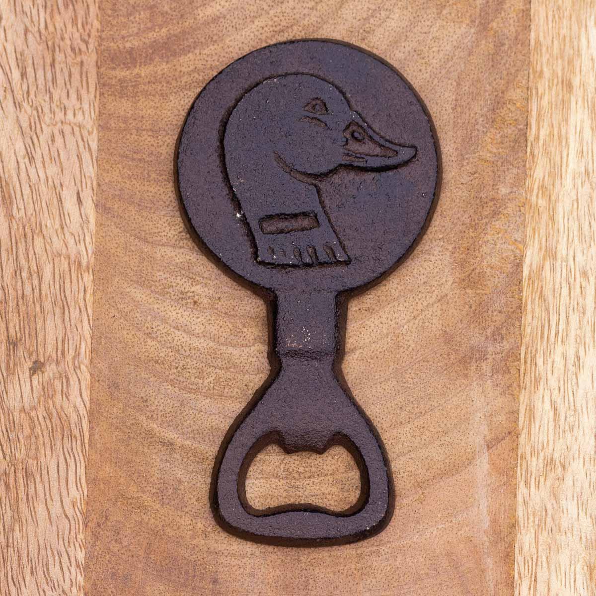 Decorative bottle opener with dog design on a wooden surface