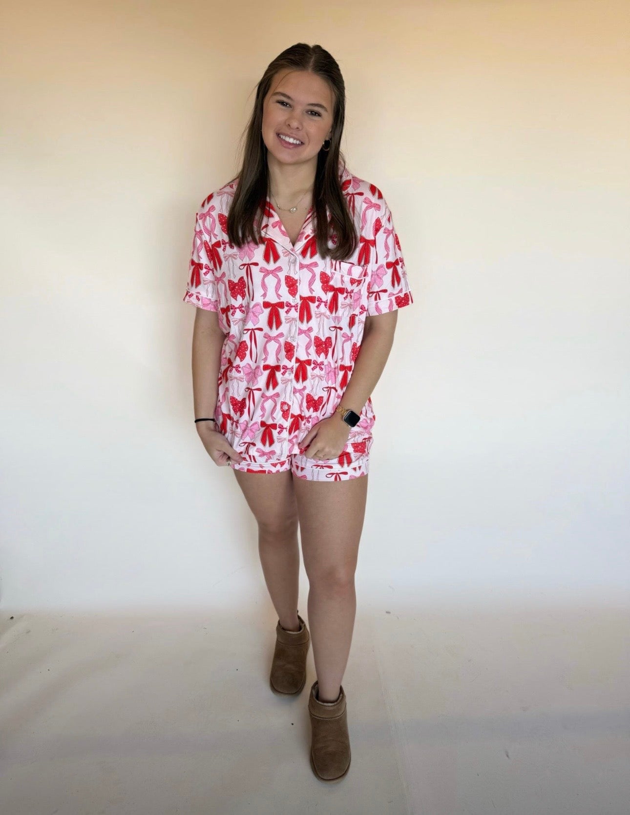 Person wearing a red and white patterned lounge set against a plain background