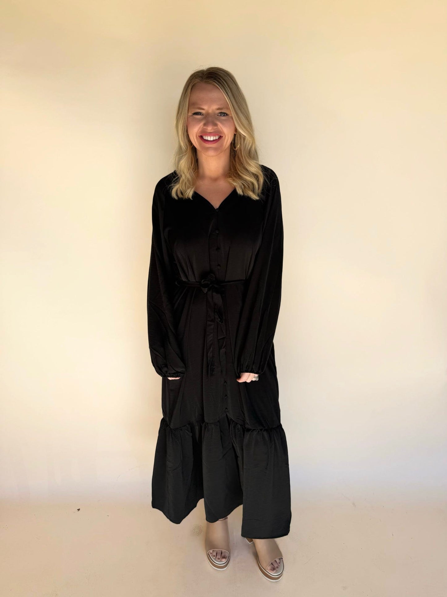 Woman wearing a black outfit against a plain background