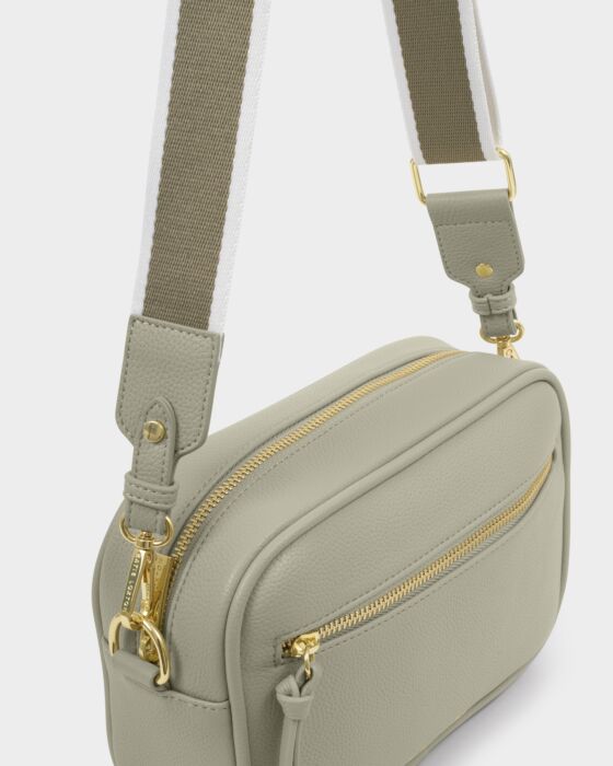 Close up of Hallie crossbody bag green mist vegan leather with gold zipper and adjustable canvas strap