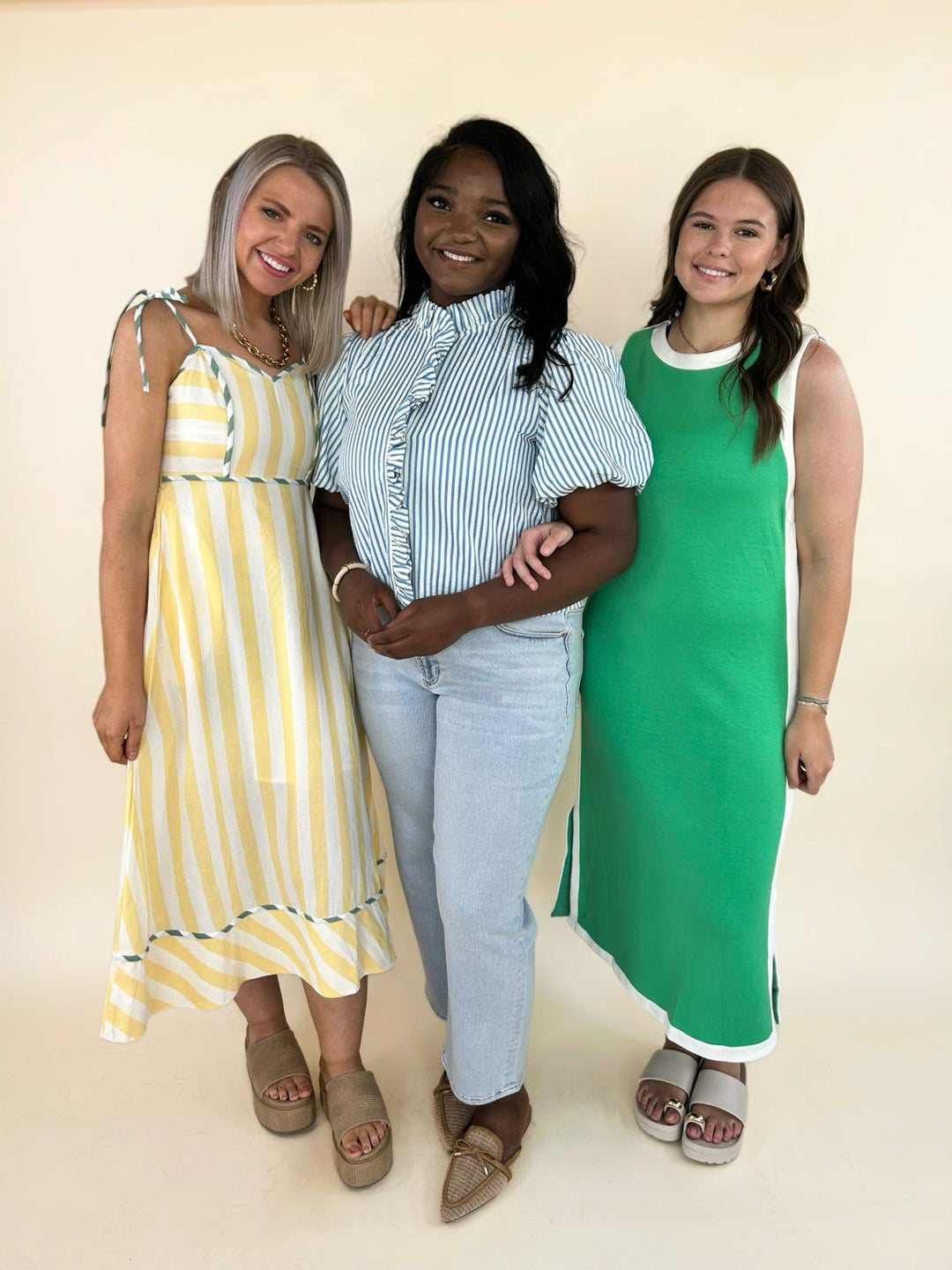 boutique summer outfits including yellow striped midi dress, blue striped ruffle blouse with light wash jeans, and green sleeveless midi dress with white trim