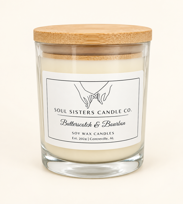 Soul Sisters Candle Co. Butterscotch and Bourbon soy wax candle in a clear glass jar with natural wood lid and white label, featuring a warm fall fragrance.