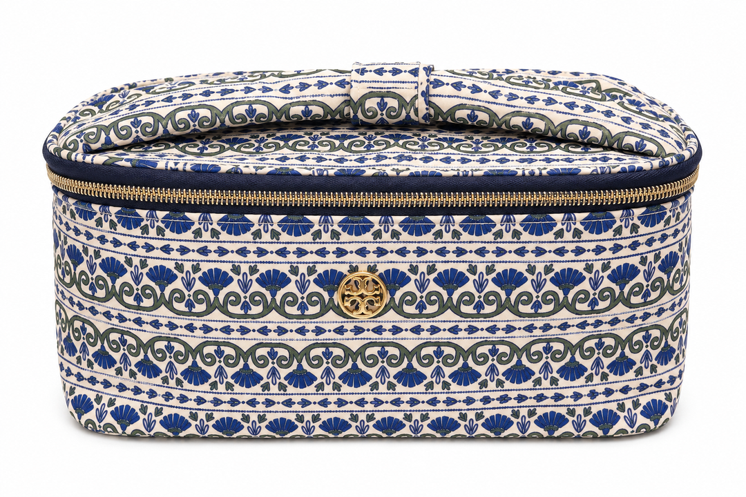 Blue and white patterned travel cosmetic case with top carry handle, gold zipper, and spacious storage for makeup, skincare, toiletries, and travel essentials.