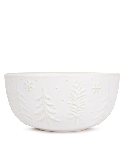 White ceramic bowl with leaf patterns on a white background