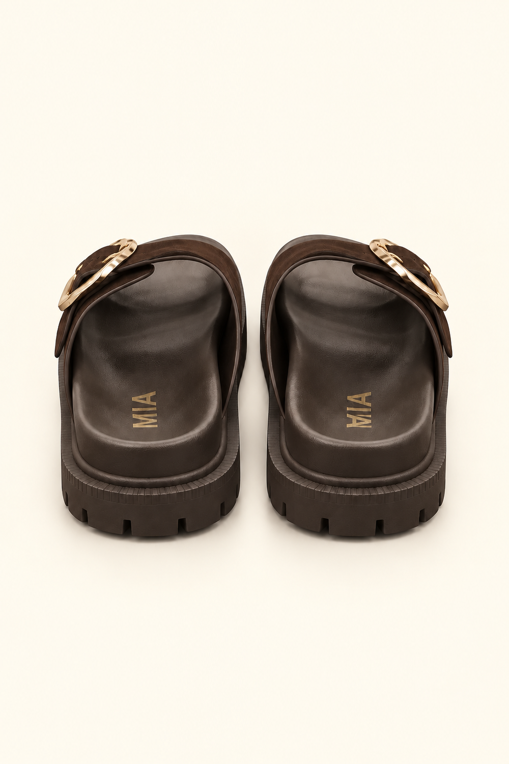 Rear view of dark brown platform slide sandals showing molded footbeds, gold logo lettering, and lug soles.