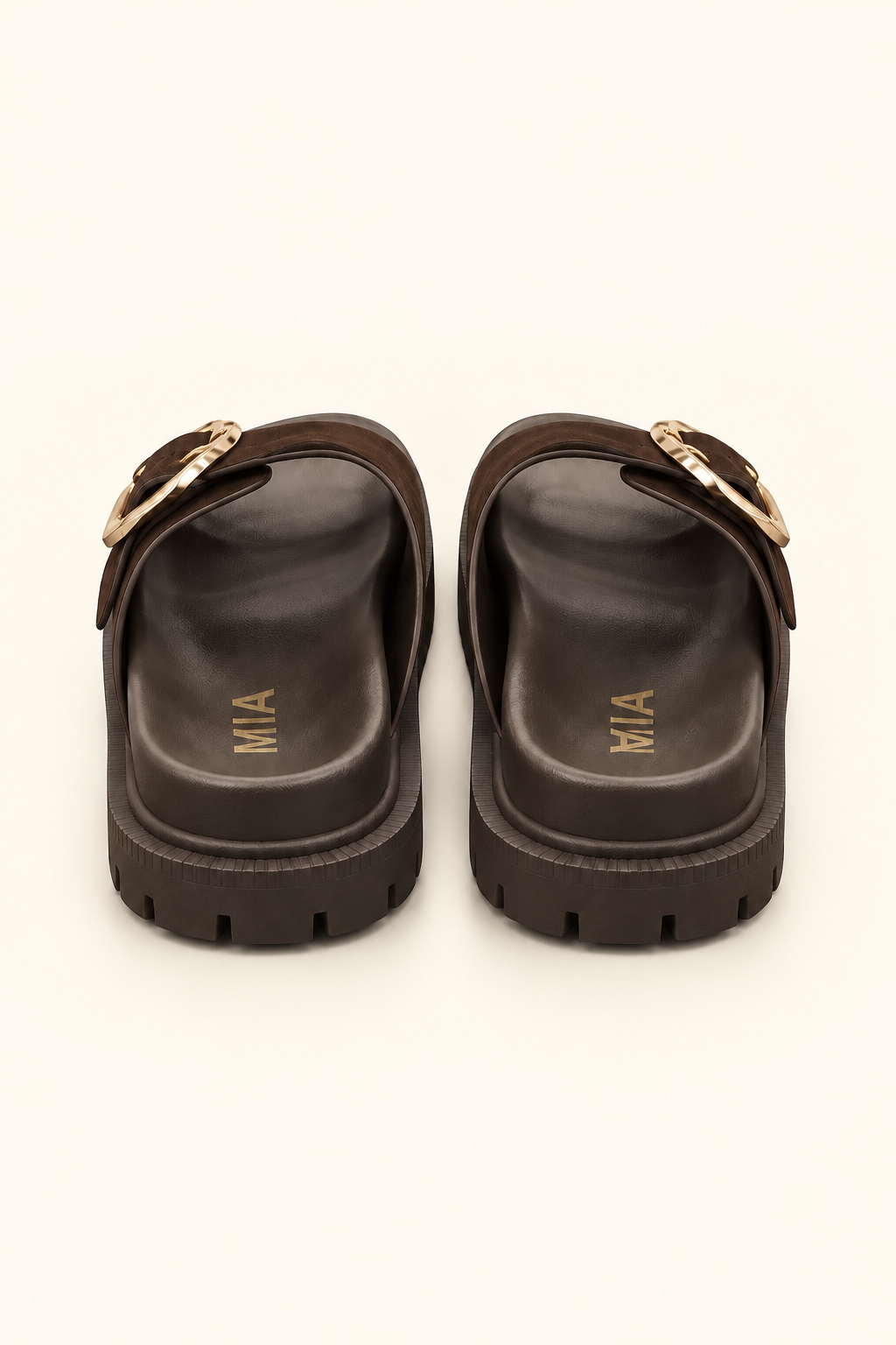 Rear view of dark brown platform slide sandals showing molded footbeds, gold logo lettering, and lug soles.