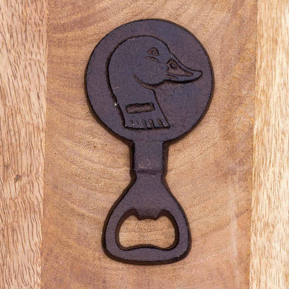 Decorative bottle opener with dog design on a wooden surface