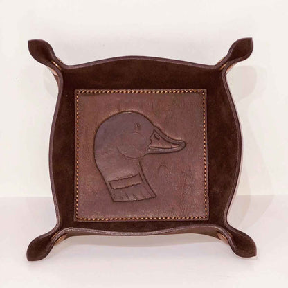 Brown leather tray with embossed duck design on a white background
