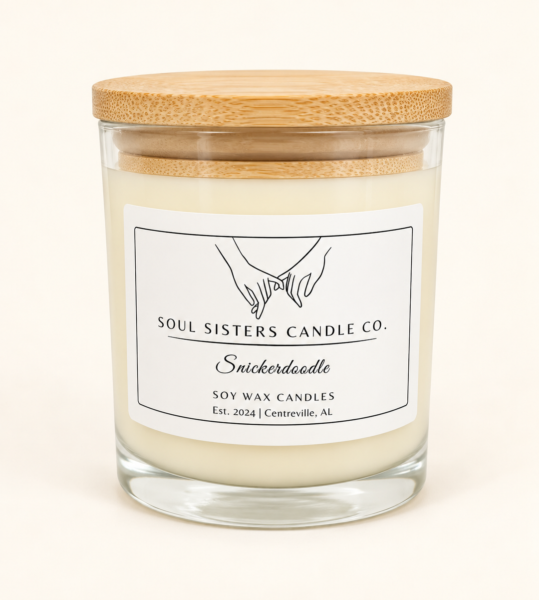 Soul Sisters Candle Co. Snickerdoodle soy wax candle in a clear glass jar with natural wood lid, featuring a sweet cinnamon sugar cookie-inspired fragrance.