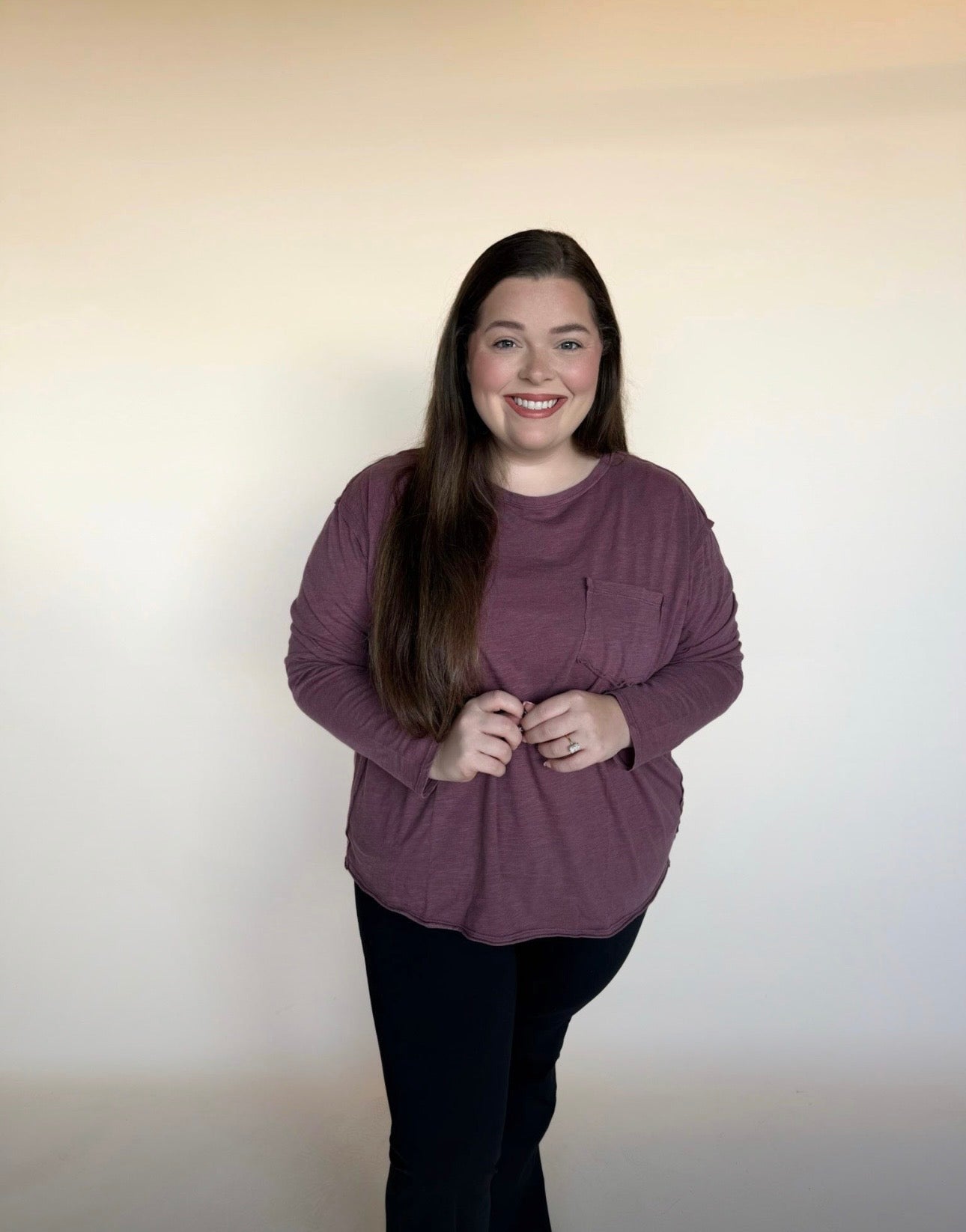 Woman wearing a purple sweater against a plain background