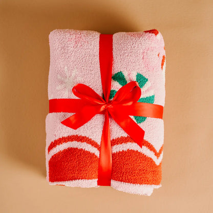 Folded towel with a red ribbon on a beige background