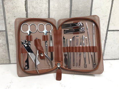 Manicure set with tools in a brown case on a white background