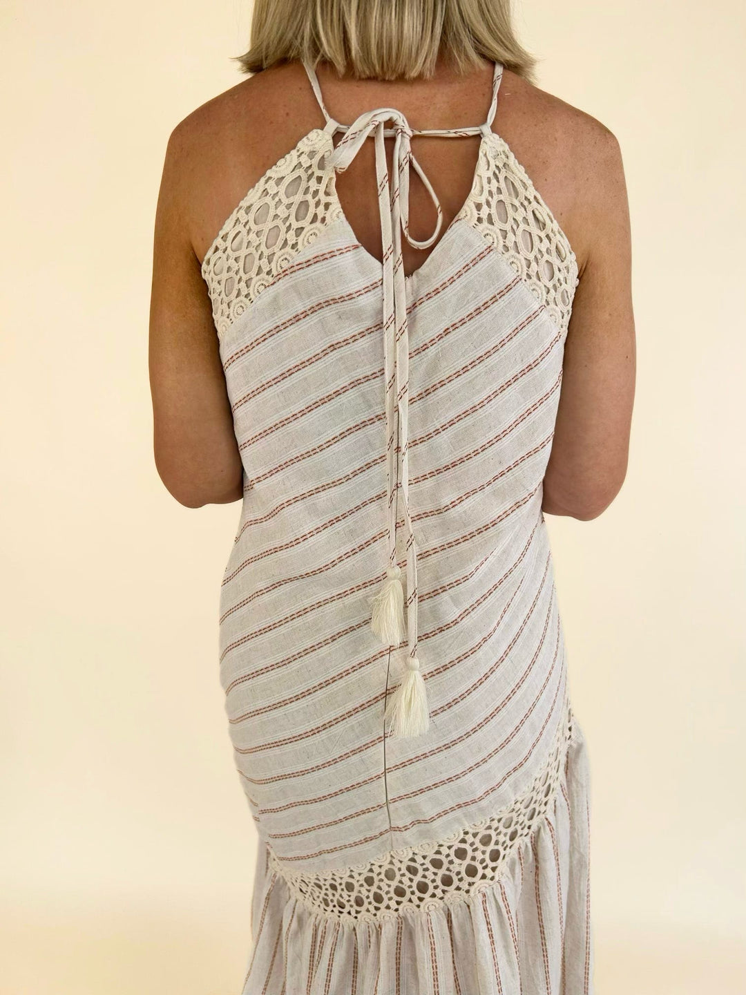 Close-up back view of the Bella Halter Cutout Tiered Maxi Dress highlighting the halter tie closure and crochet lace detailing.