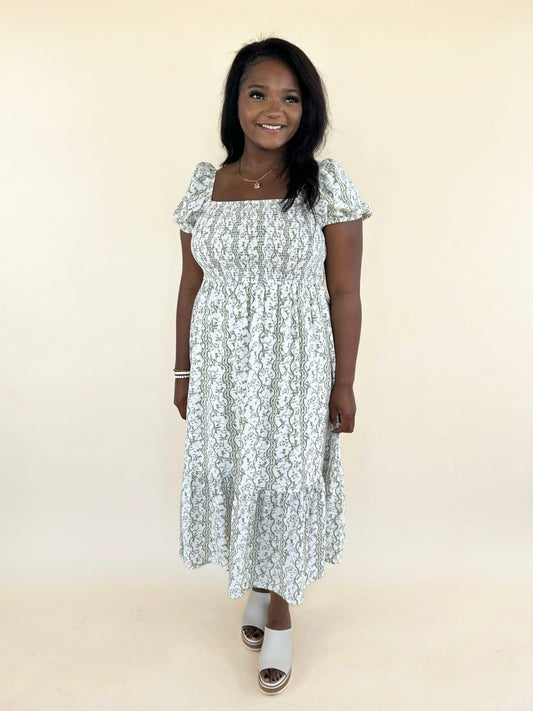 Olive green floral smocked midi dress with puff sleeves front view