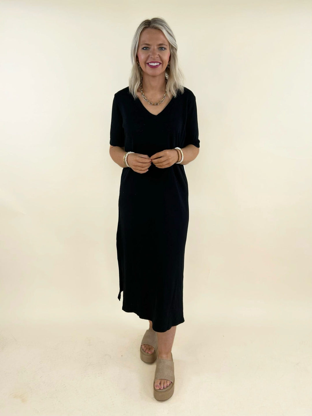 Black v-neck midi t-shirt dress for women, short sleeve casual midi dress, relaxed fit black knit dress, versatile everyday wardrobe staple, comfortable boutique fashion dress, minimalist women&