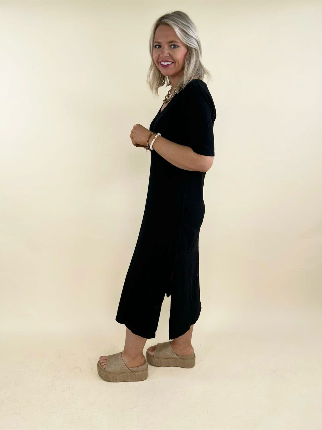 Black v-neck midi dress side view with short sleeves and side slit, women&