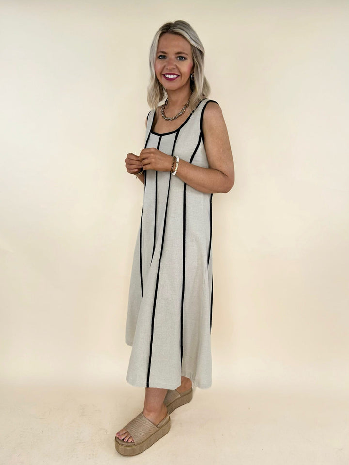 Natural sleeveless midi dress side view, black contrast piping dress, women&