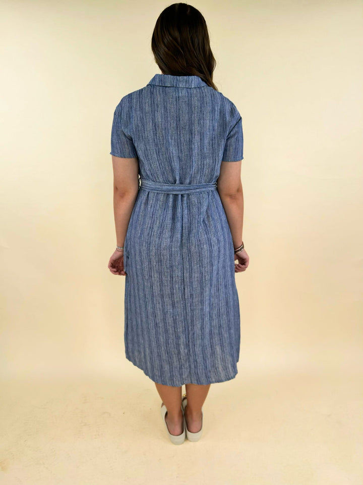 Back view of blue striped midi shirt dress with belt detail, short sleeves, lightweight fabric, women’s boutique clothing