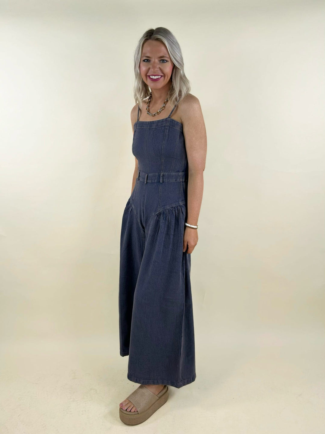blue denim wide leg jumpsuit side view belted waist sleeveless summer outfit women’s boutique