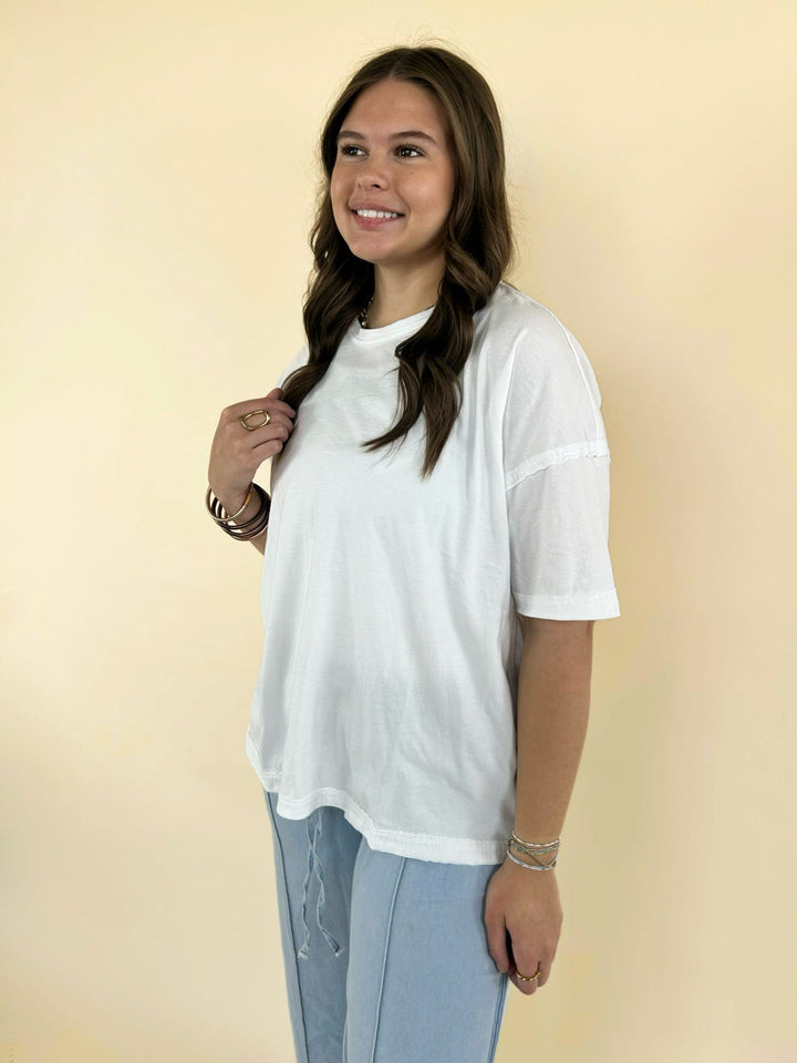 white oversized tee side view with light blue wide leg pants casual comfy women’s outfit
