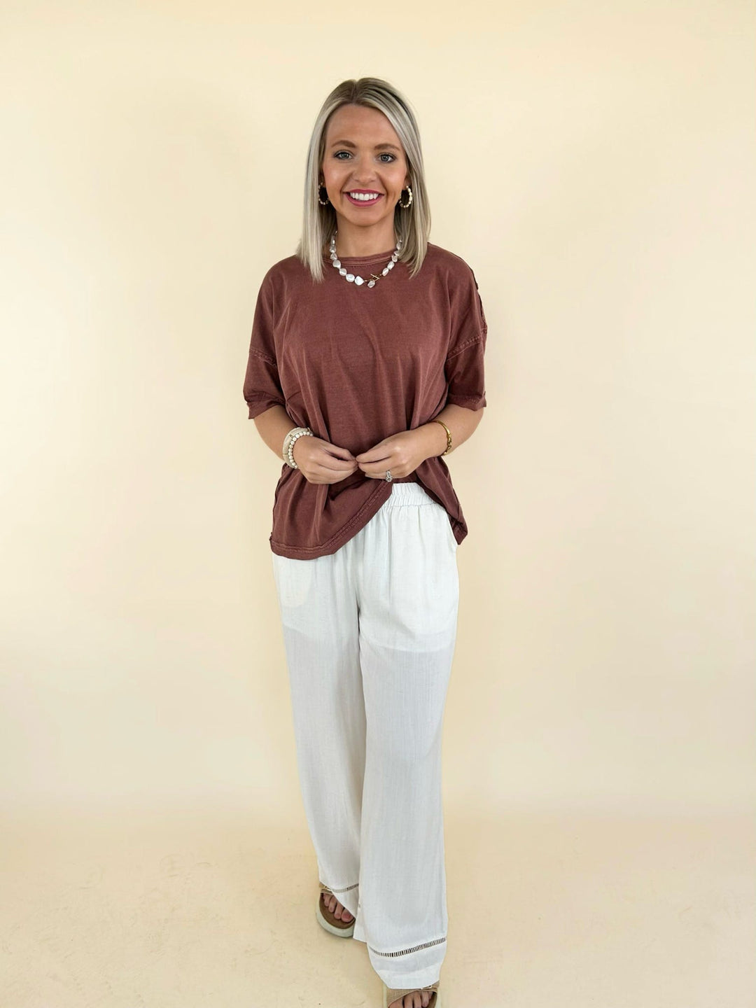 rust oversized tee front view with cream wide leg pants relaxed fit casual outfit women’s boutique