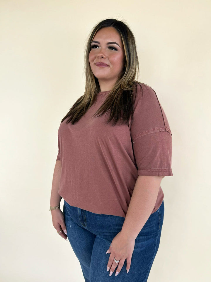 rust oversized short sleeve tee styled with dark wash denim jeans casual plus size women’s outfit