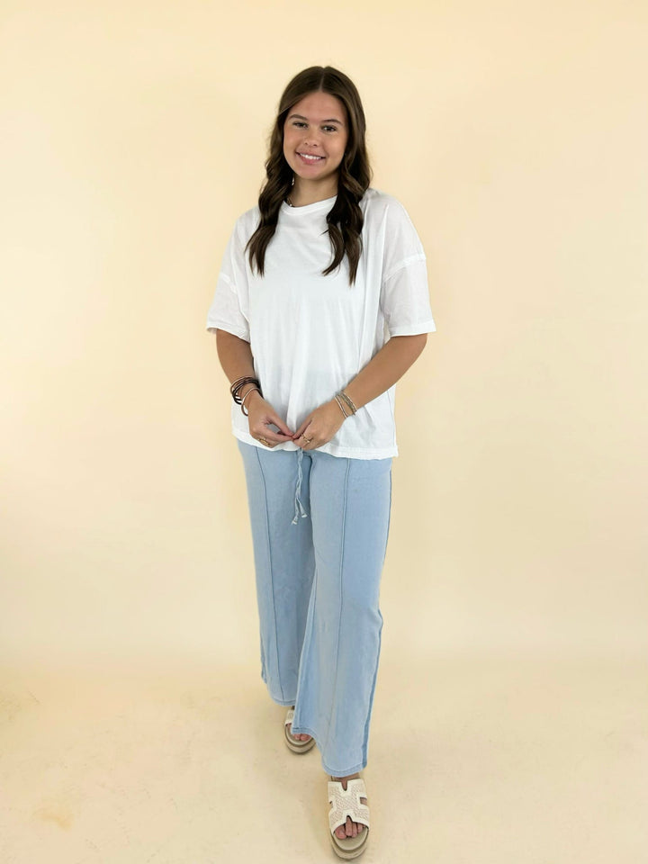 white oversized tee front view with light blue wide leg lounge pants relaxed casual outfit