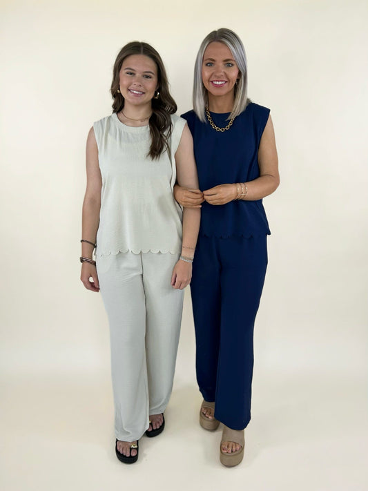 matching lounge sets in cream and navy with sleeveless scalloped hem tops and wide leg pants