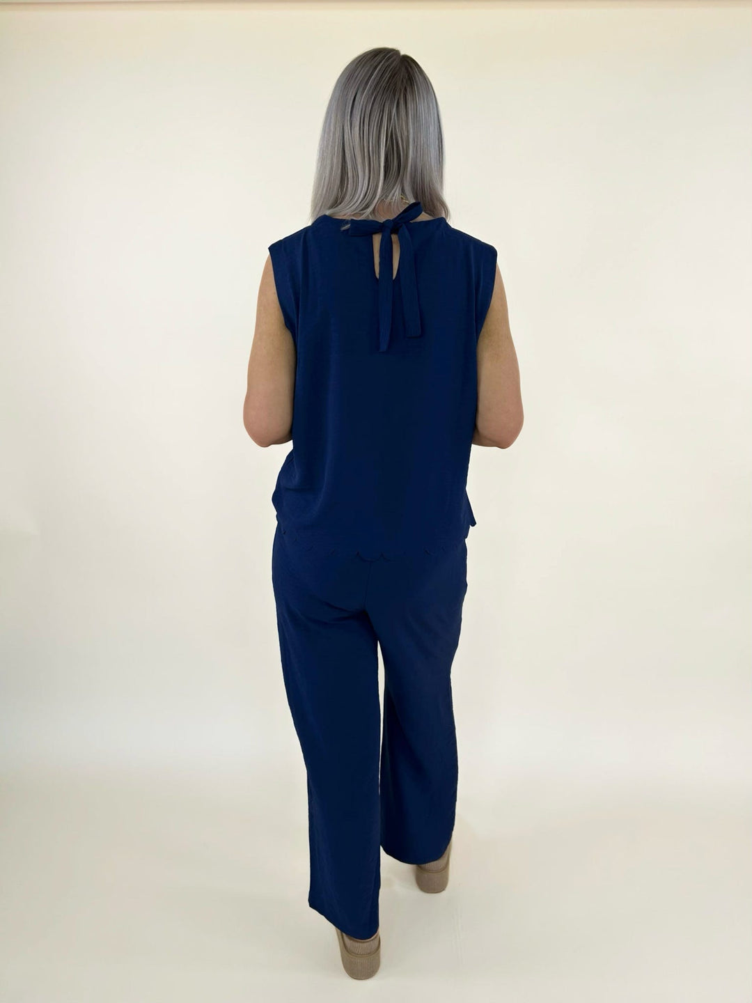 Back full body view of navy matching set with sleeveless top and wide leg pants