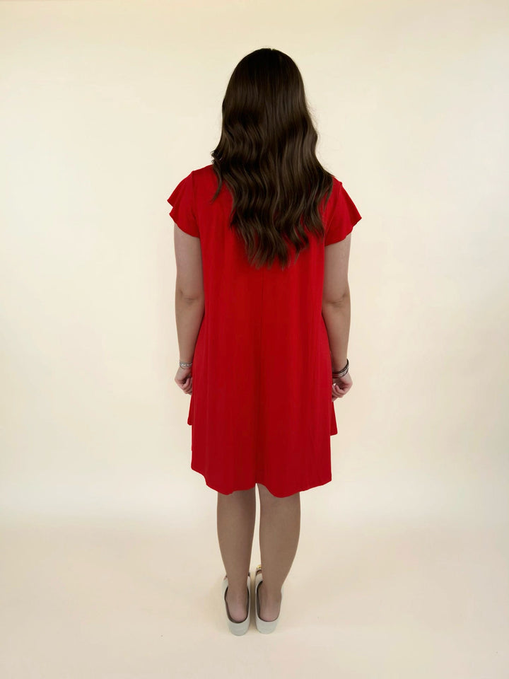 Back view of red short sleeve swing dress with relaxed fit and flowy silhouette