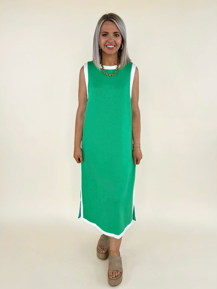 Green sleeveless midi dress with white trim detail styled with platform sandals, front view women’s boutique outfit
