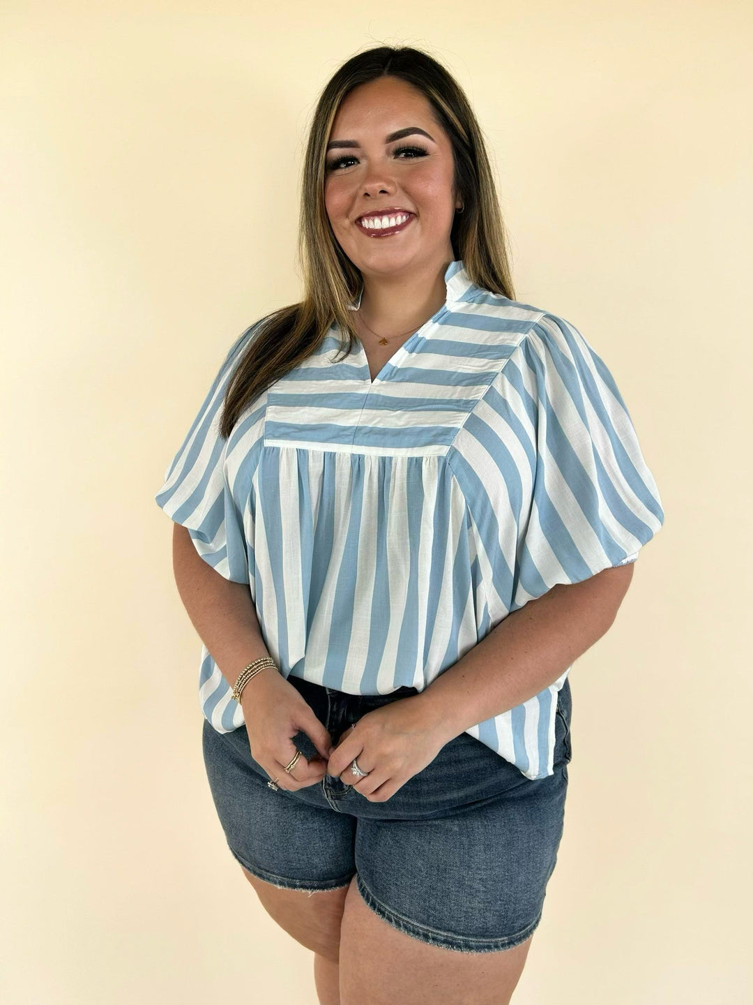 blue and white striped blouse styled with denim shorts