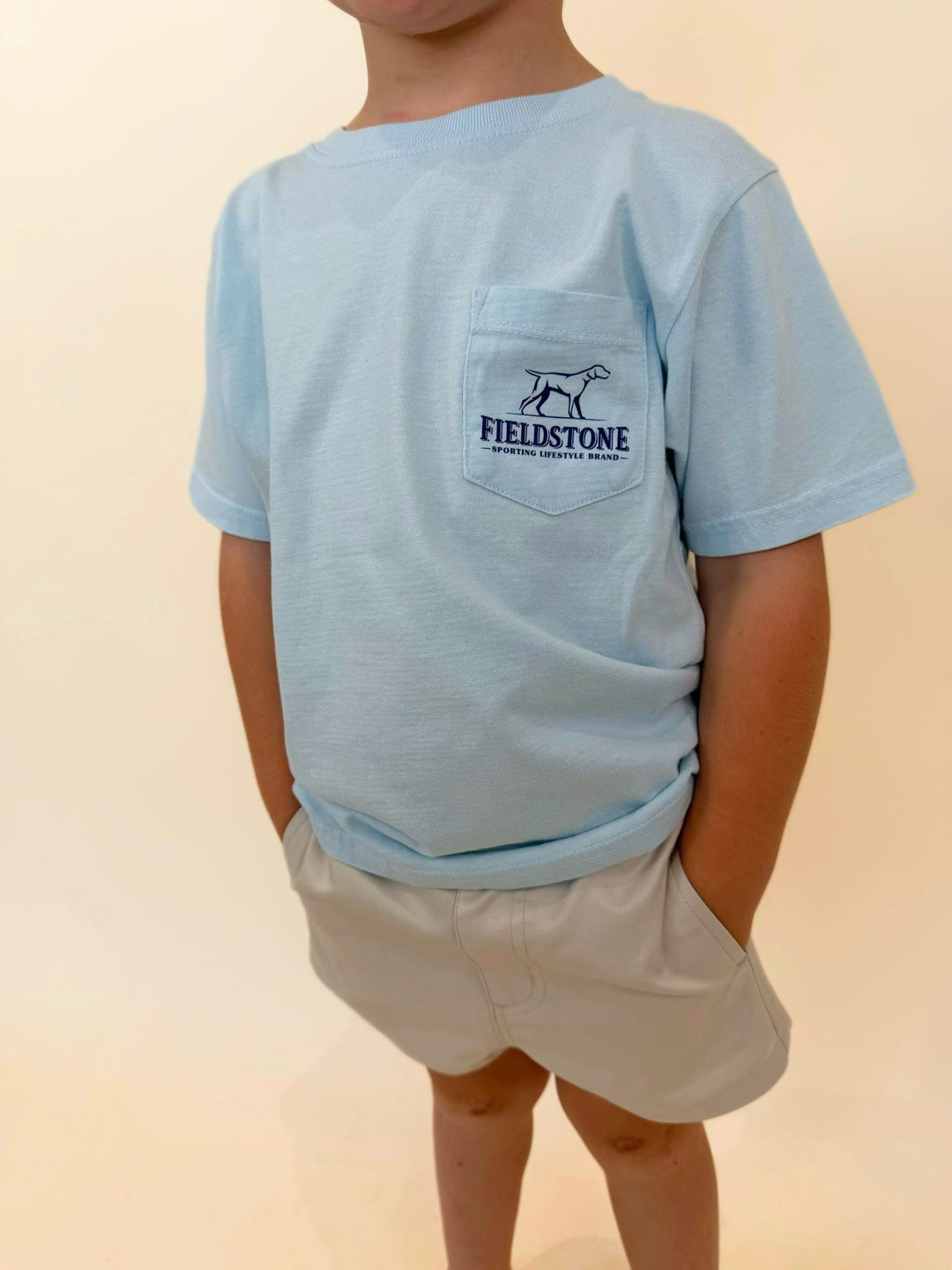 Close-up of youth Fieldstone pocket t-shirt, light blue boys graphic tee featuring Fieldstone Sporting Lifestyle Brand logo, soft cotton everyday kids shirt