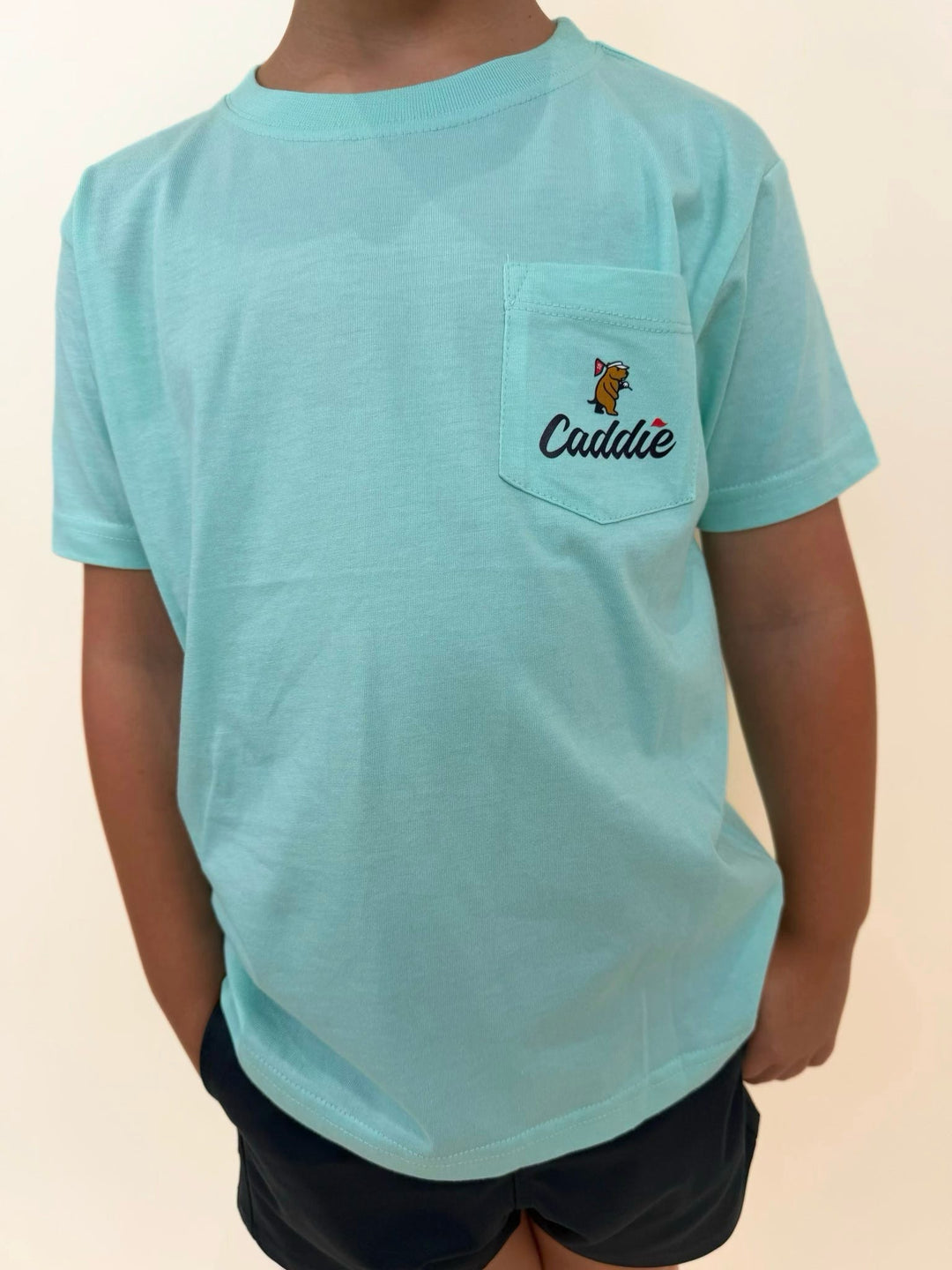 Youth Caddie pocket t-shirt in aqua blue, boys golf lifestyle tee with Caddie logo pocket, soft cotton short sleeve shirt for kids, southern golf apparel