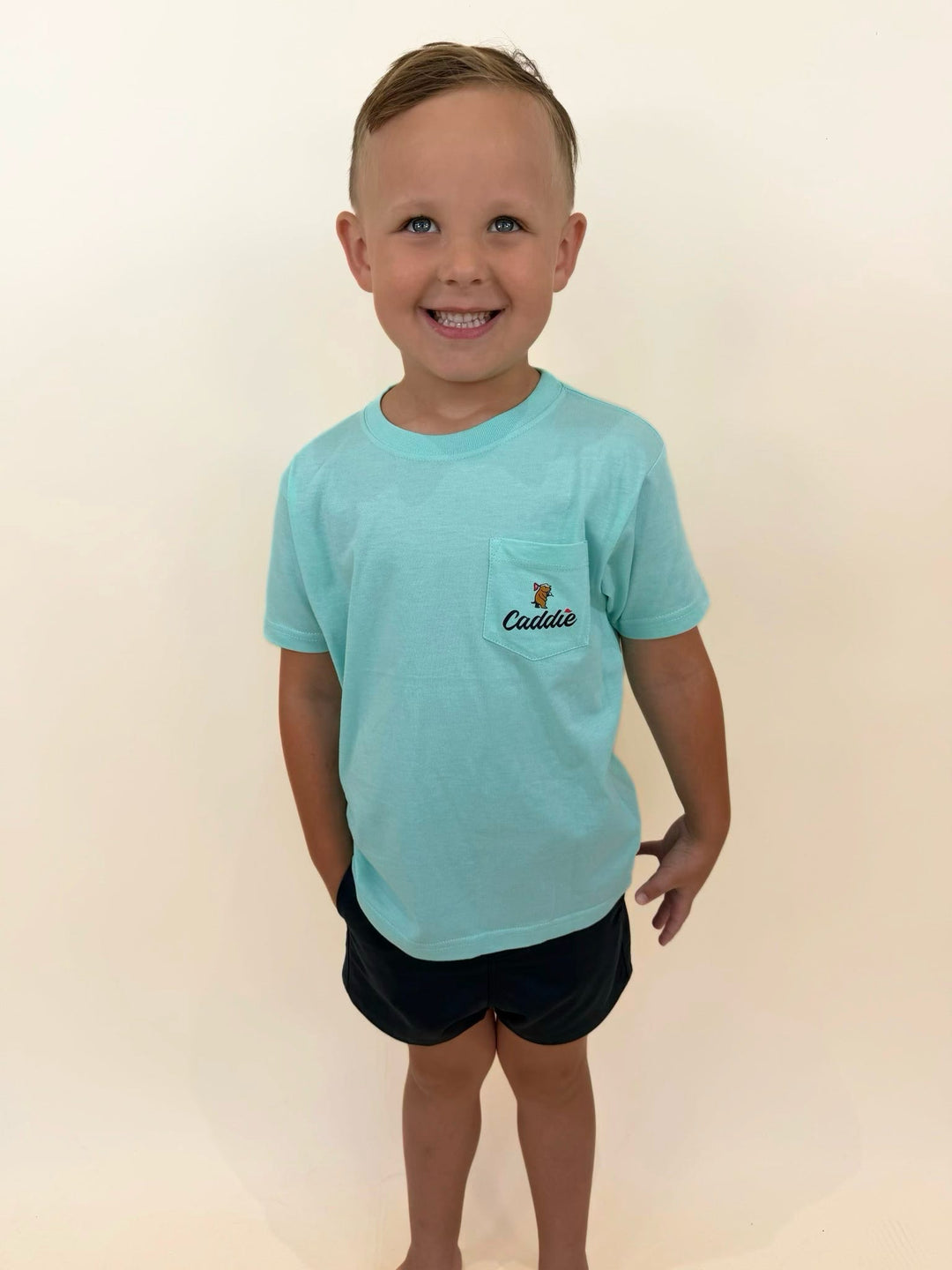 Youth Caddie aqua blue pocket t-shirt for boys, comfortable cotton golf lifestyle shirt with embroidered pocket logo, casual everyday kids apparel