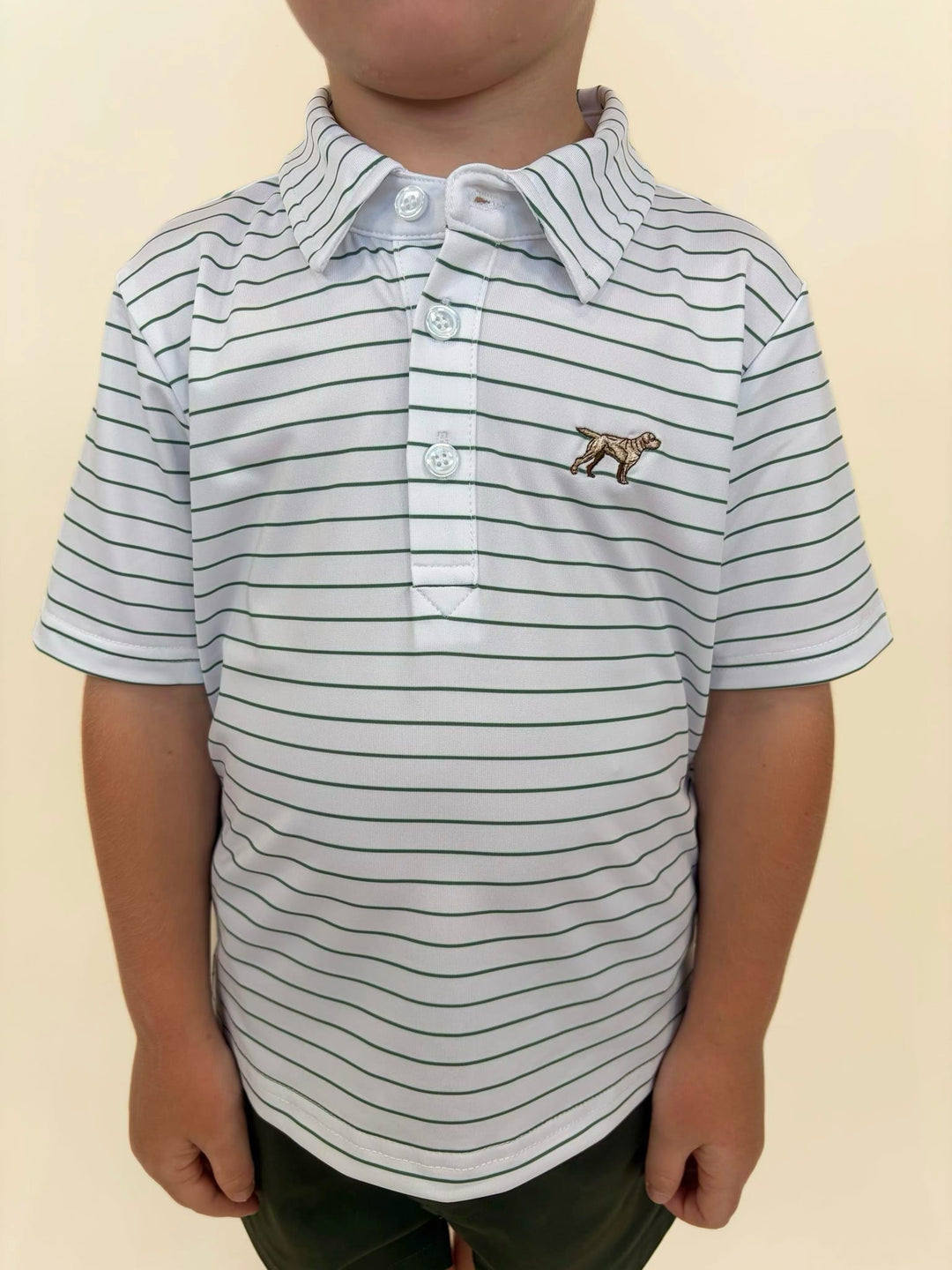 Fieldstone youth performance polo with embroidered sporting dog logo, white polo with green pinstripes, boys golf and outdoor lifestyle shirt detail