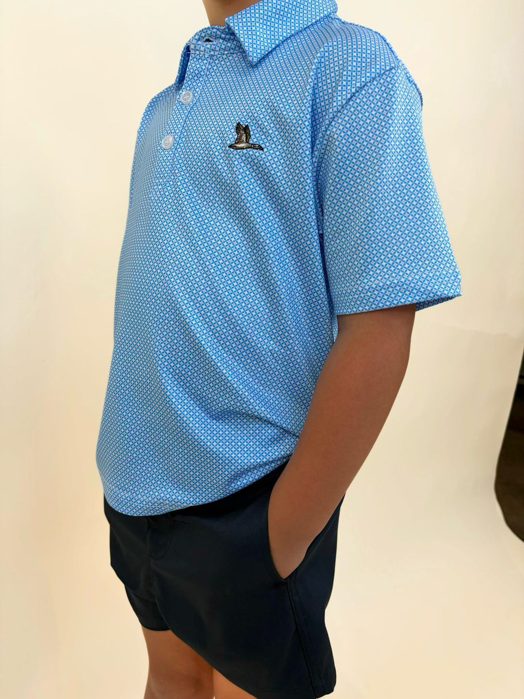 Side view of boys Roost Waterfowl polo, blue patterned performance shirt, breathable youth golf polo, comfortable boys southern style clothing