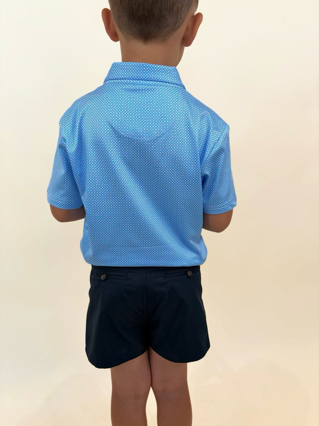 Back view of Roost Waterfowl youth performance polo, blue patterned boys golf shirt, lightweight moisture-wicking polo, classic outdoor lifestyle apparel for kids
