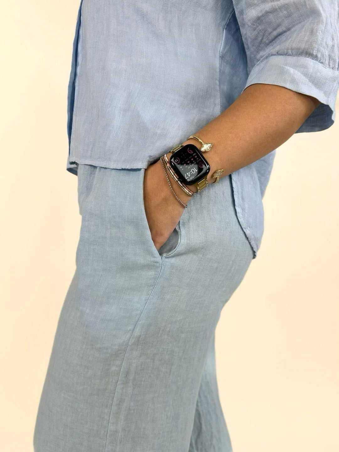 Close-up of light blue linen wide-leg pants showcasing the breathable fabric, functional side pocket, relaxed fit, and comfortable elastic waistband for effortless everyday wear.