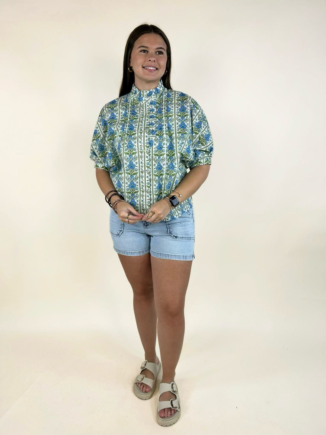 Entro blue botanical print blouse styled with light wash denim shorts and sandals
