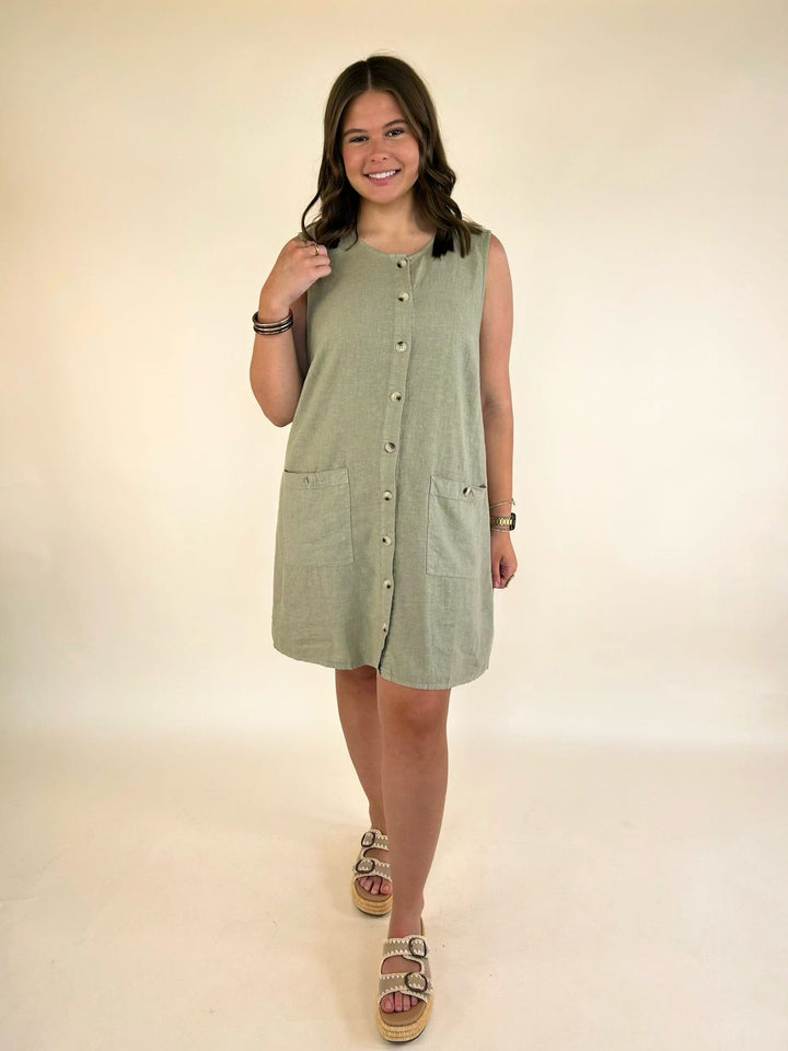 Full-length view of the Dear John Riri linen blend sleeveless mini dress in Abbey Stone styled with platform sandals.