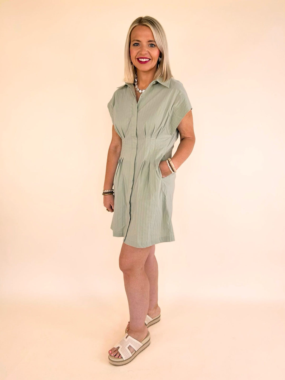 Full-length view of the THML sage striped collared mini dress styled with platform sandals for a casual chic look.