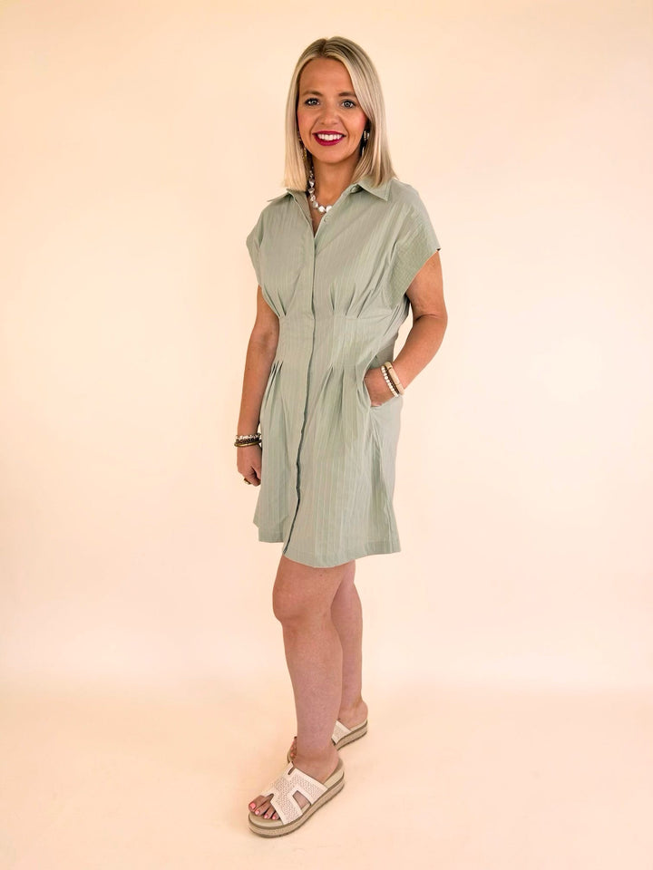 Full-length view of the THML sage striped collared mini dress styled with platform sandals for a casual chic look.