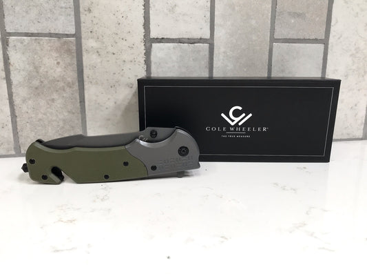 Folding knife with a black box featuring 'Cole Wheeler' logo on a light gray background.