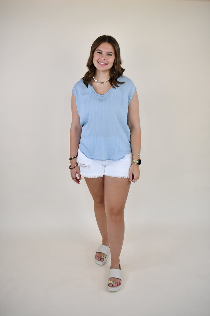 Woman wearing the Dear John Yanis V-Neck Cap Sleeve Top in Skyway Light Wash featuring a relaxed fit, V-neckline, and cap sleeves.