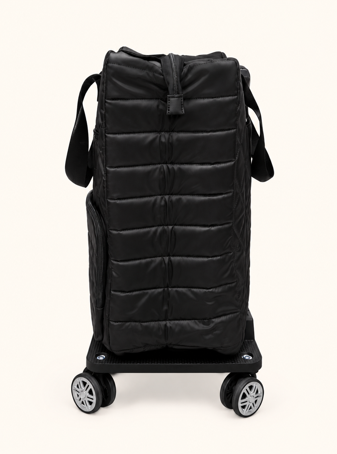 Side view of Simply Southern black quilted swivel rolling tote showing padded horizontal stitching, zippered closure, and spinner wheel base.