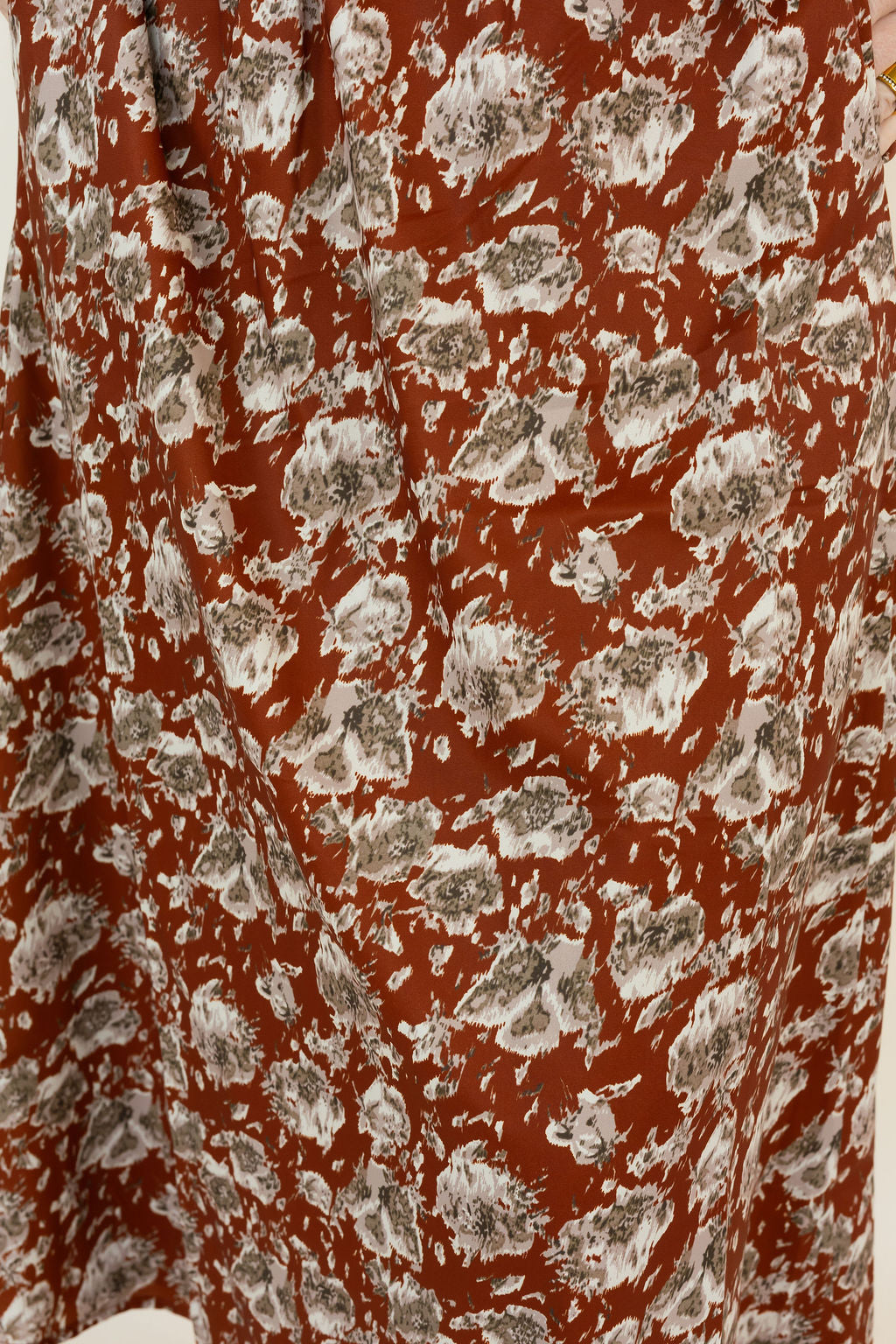 A close-up of a hickory fabric with an all-over abstract floral style print in white and gray.