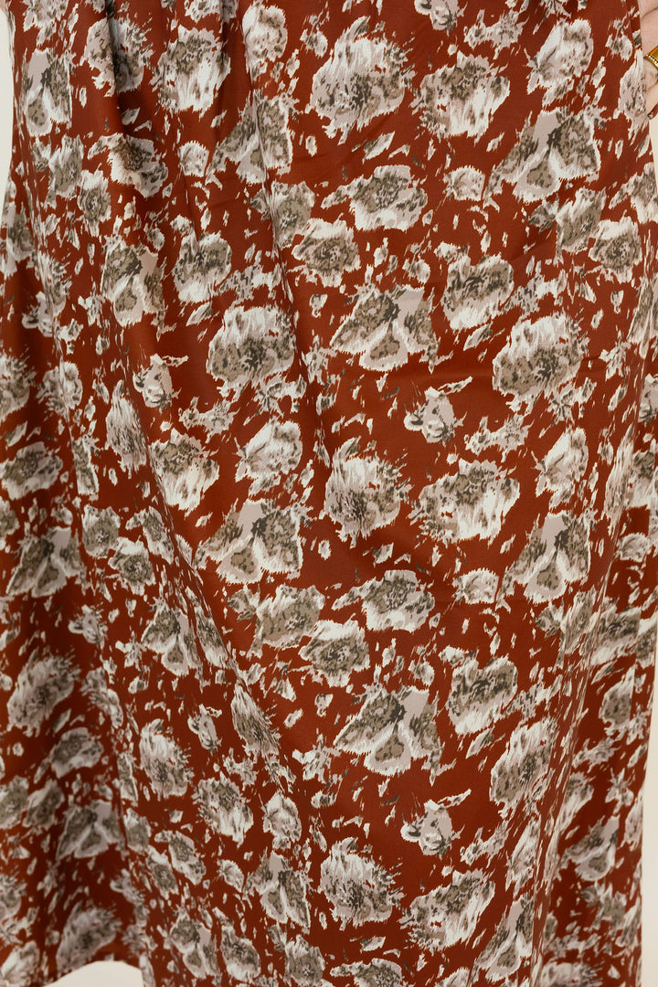 A close-up of a hickory fabric with an all-over abstract floral style print in white and gray.