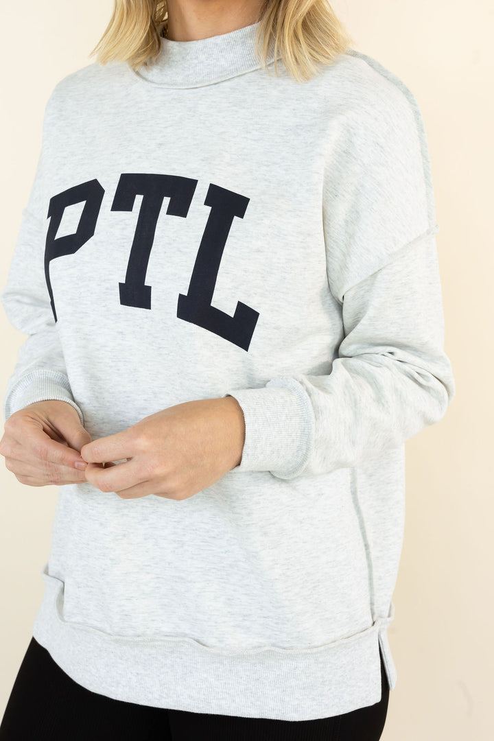 A light heather gray sweatshirt with the letters &