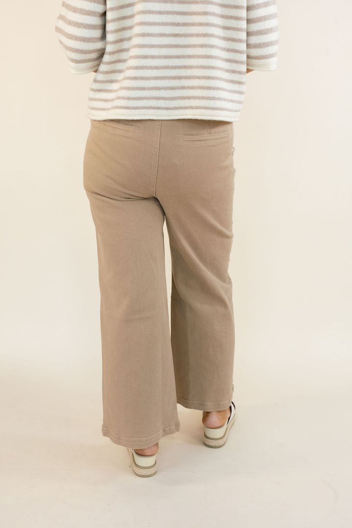 Back view of taupe cropped wide leg pants showing the relaxed silhouette, wide legs, and ankle-length hem